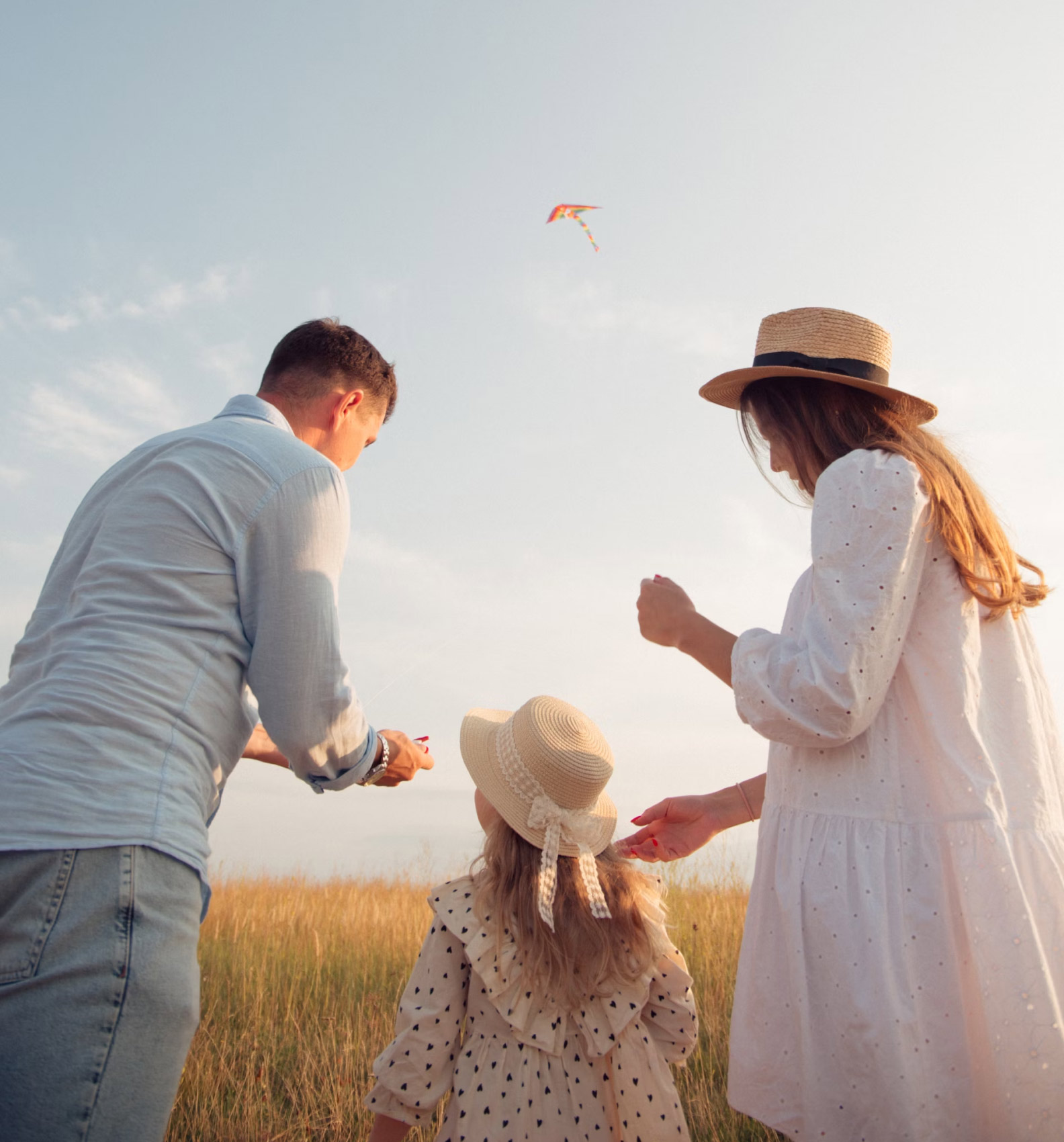 a family of three on the field flying some kite, as part of psychological services in nova scotia